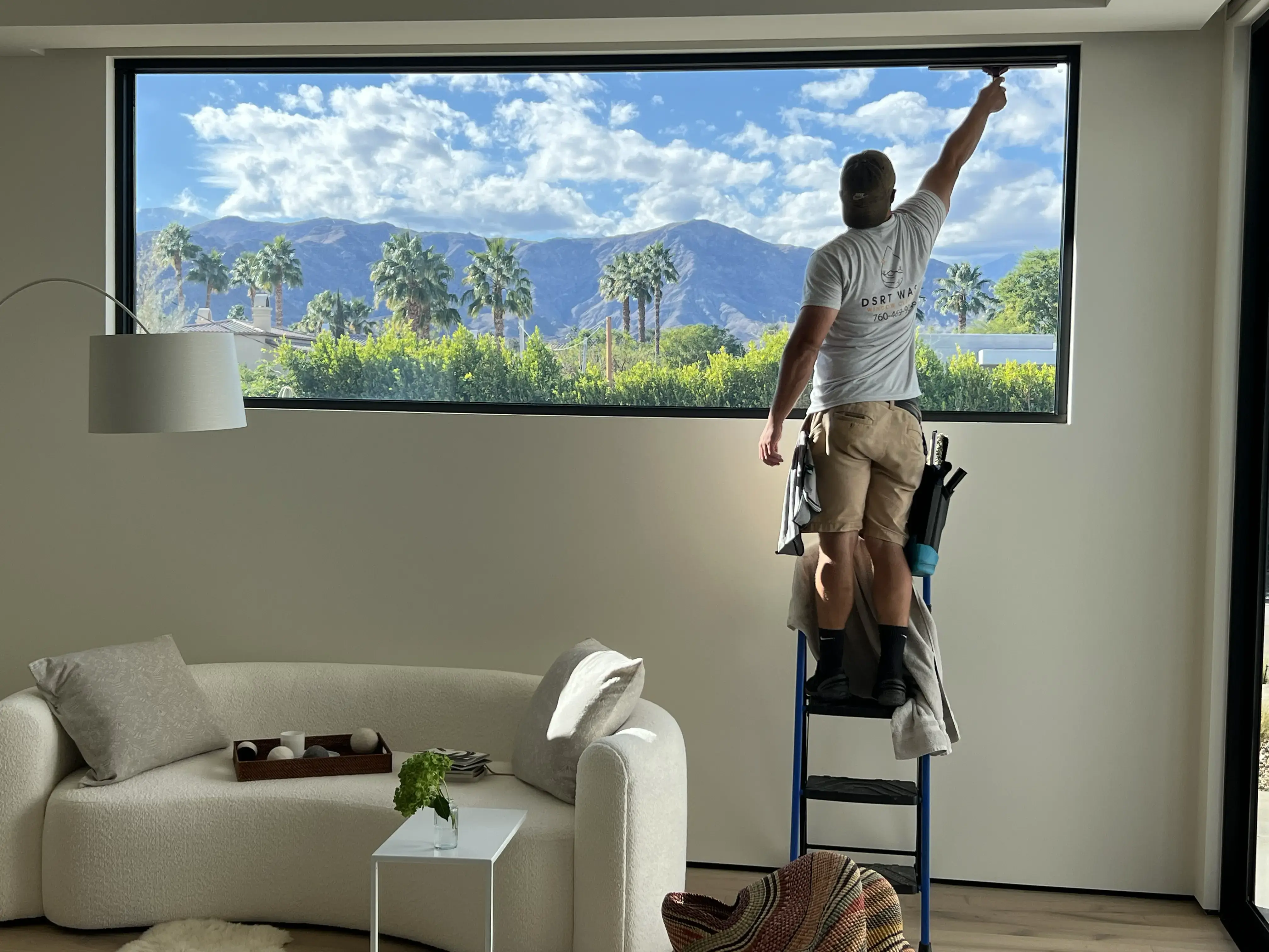 Close-up of clean residential window reflecting the desert sky.