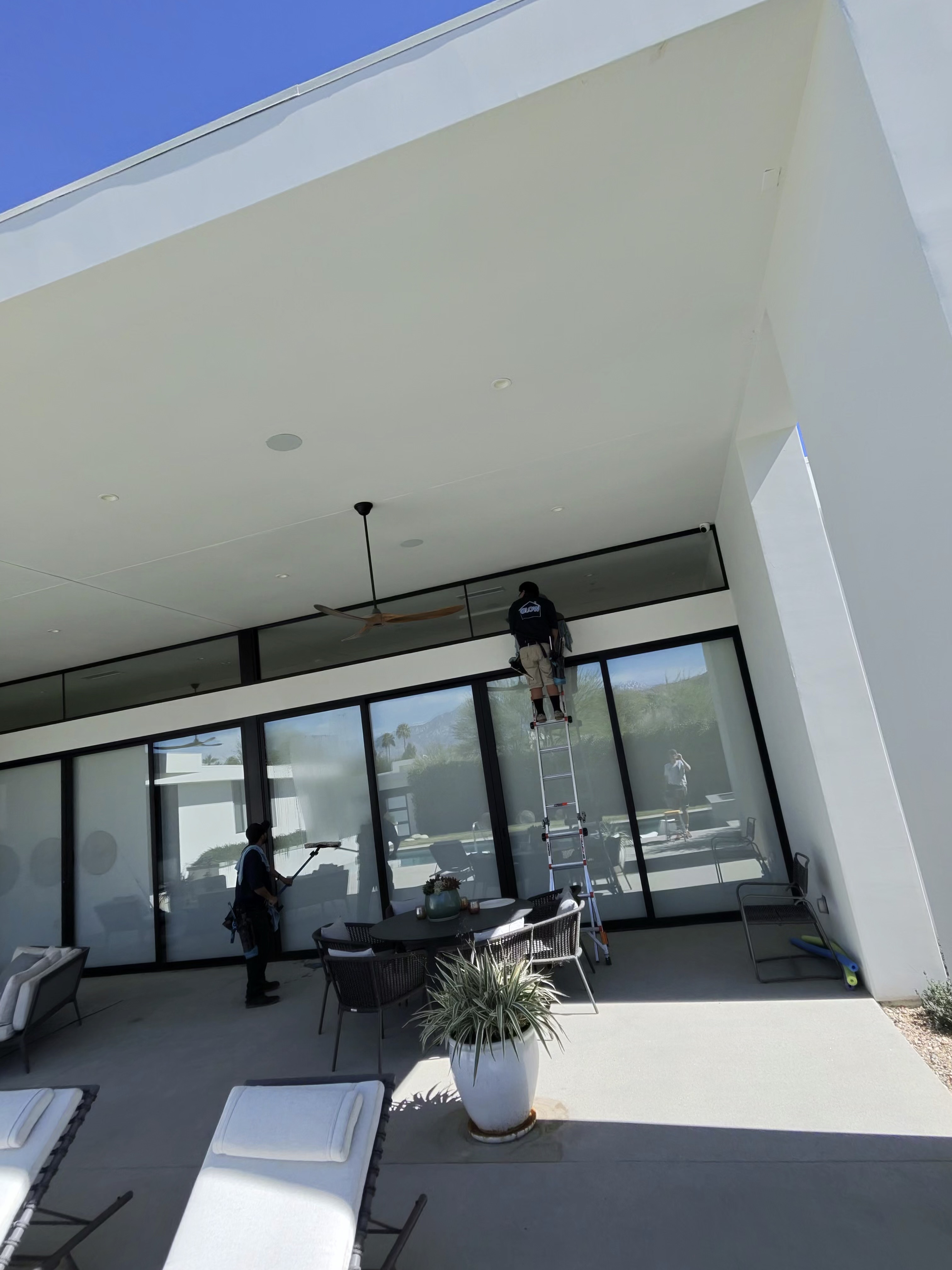 Glow team cleaning the exterior of a modern La Quinta home