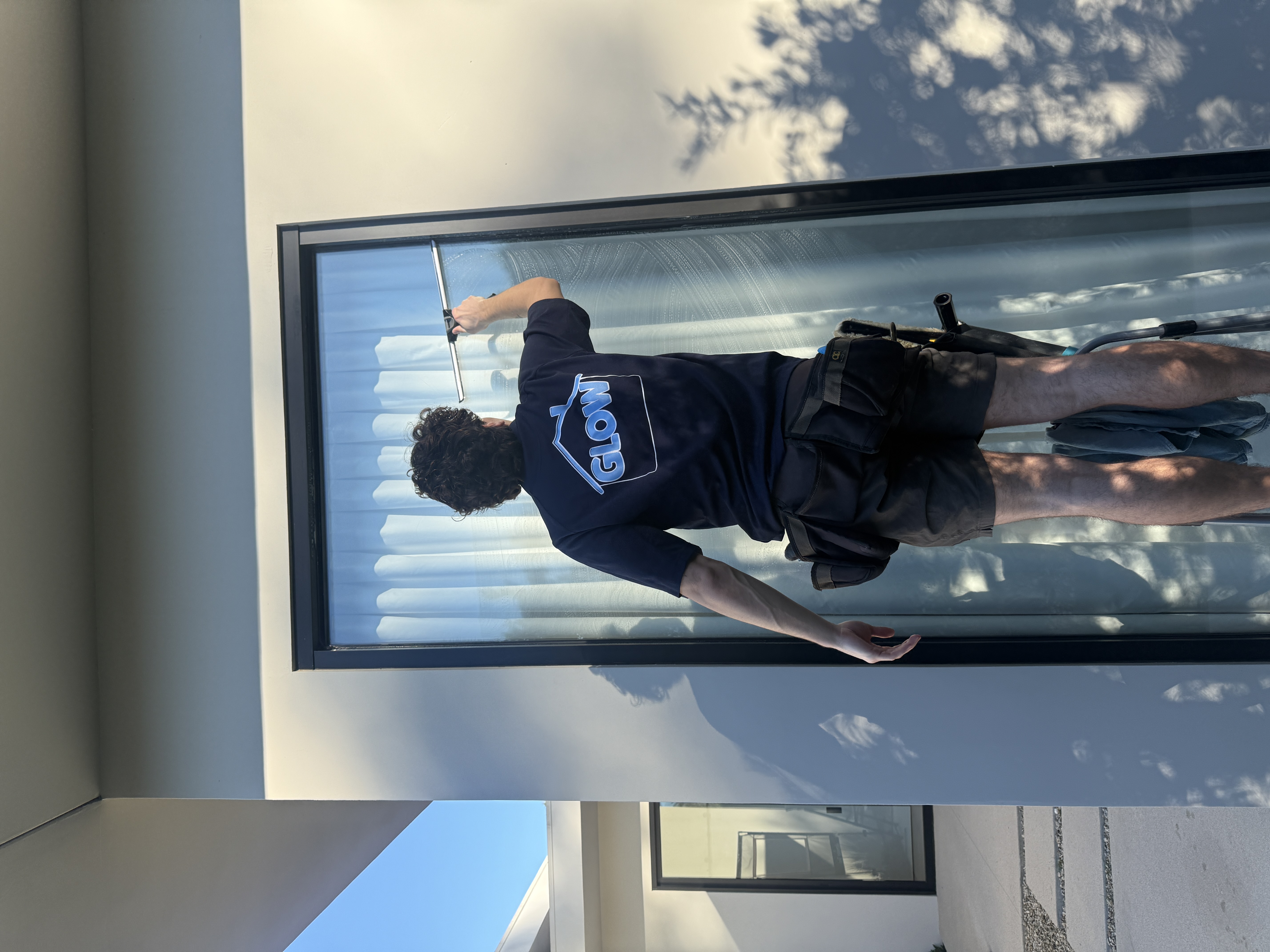 Exterior window cleaning on modern home